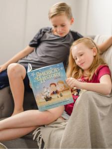 Family on couch reading together.
