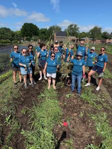 Aptia Group Team members pose for a photo during the garden beautification volunteer event