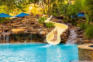 child sliding down pool