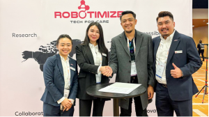 Official partnership signing ceremony on 13 May 2025, showing Kerry Guo (Robotimize Founder & CEO), Simon John Rodriguez (TWD CEO), Viv Lee (Robotimize BDM), and Even Koh (Robotimize Group GM) standing together and smiling.