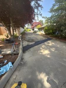 Indepth Excavation fills and covers the trenches with asphalt