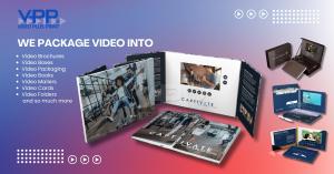 Person opening a custom Video Plus Print product, featuring a full-color printed brochure with an embedded LCD screen displaying a promotional video. The image shows the engaging unboxing experience of a Video Brochure, highlighting the combination of hig