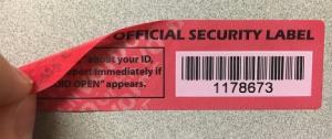 A half-opened label showing the security features, including text that says "VOID OPEN"