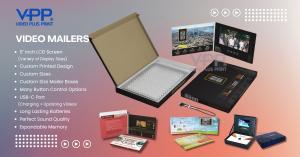 Person opening a Video Mailer featuring custom printed packaging with an integrated LCD screen playing a video message. The image highlights the direct mail format, vivid print design, and interactive video element that creates a memorable and engaging un
