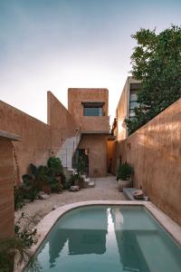 Exterior view of Portal 62 showing its orange earthen façade, exterior staircase, and two-bedroom configuration.
