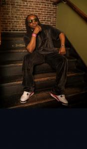 Photo of international artist ZNi sitting on steps