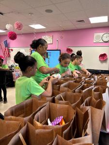 Embrace Girls preparing Thankgiving meal donations.