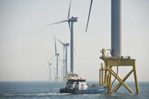 A boat lands at the base of a wind turbine at Scottish Power's East Anglia One offshore wind farm