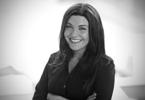 Cory Decker, founder and principal interior designer at Studio LEA, photographed in a professional headshot.
