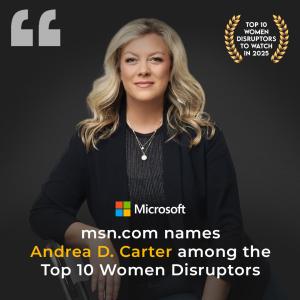 Andrea D. Carter is named a Top 10 Women Disruptor to Watch in 2025. She sits on a chair with a blue jacket and blue pinstriped shirt.