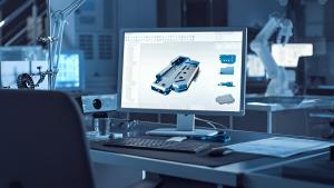 Computer screen displaying a 3D CAD model of an industrial mechanical component in a modern engineering design office.