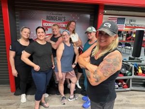 6 women and their Trainer standing together