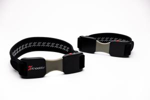 Close-up of the KneeMo® wearable devices, showing the sleek black and gray design.