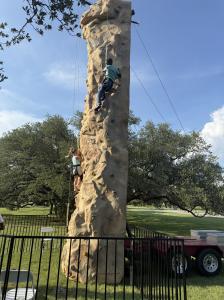 Mobile Rock Climbing Wall rental in Houston for fall festivals, school carnivals, church events, and company celebrations from Dino Jump USA.