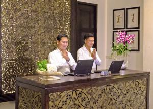 two men doing the welcome gesture of Cambodians