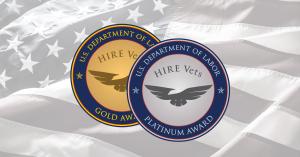 A silver medallion and gold medallion against a US flag background