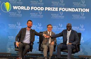 Chris Greene and two other speakers on stage at the 2025 Borlaug Dialoge